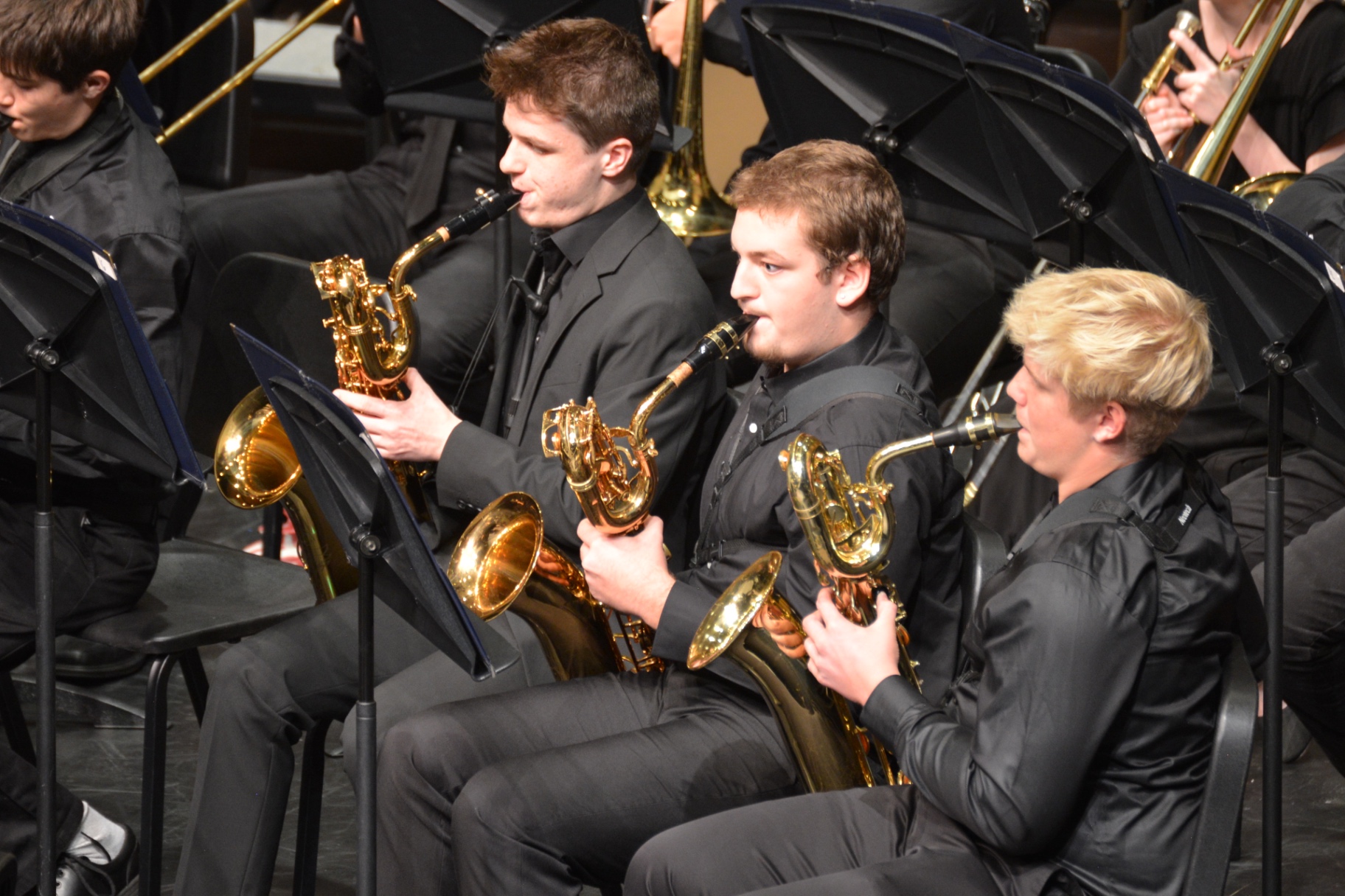 Baritone saxophone players performing in concert band
