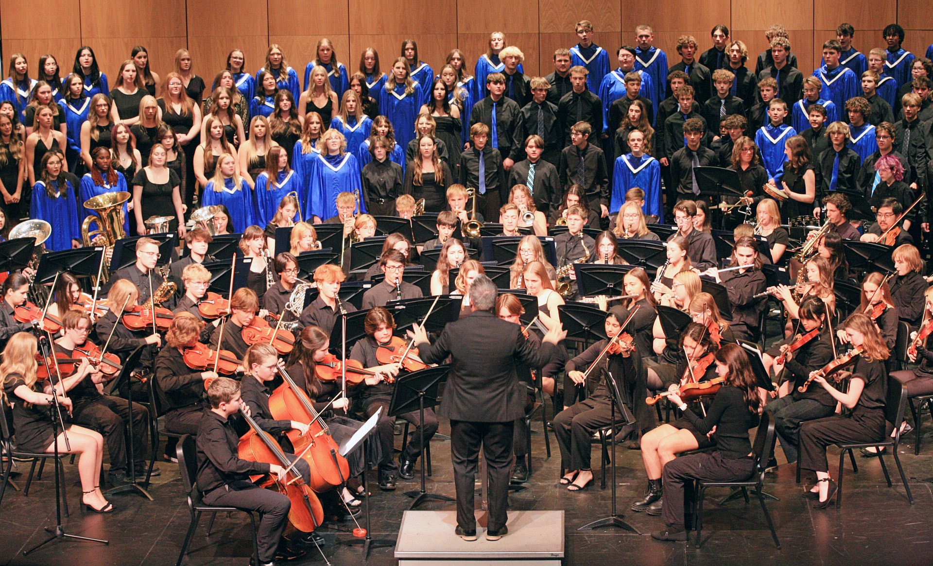 Sartell band, orchestra, and choir students performing together at the fall concert