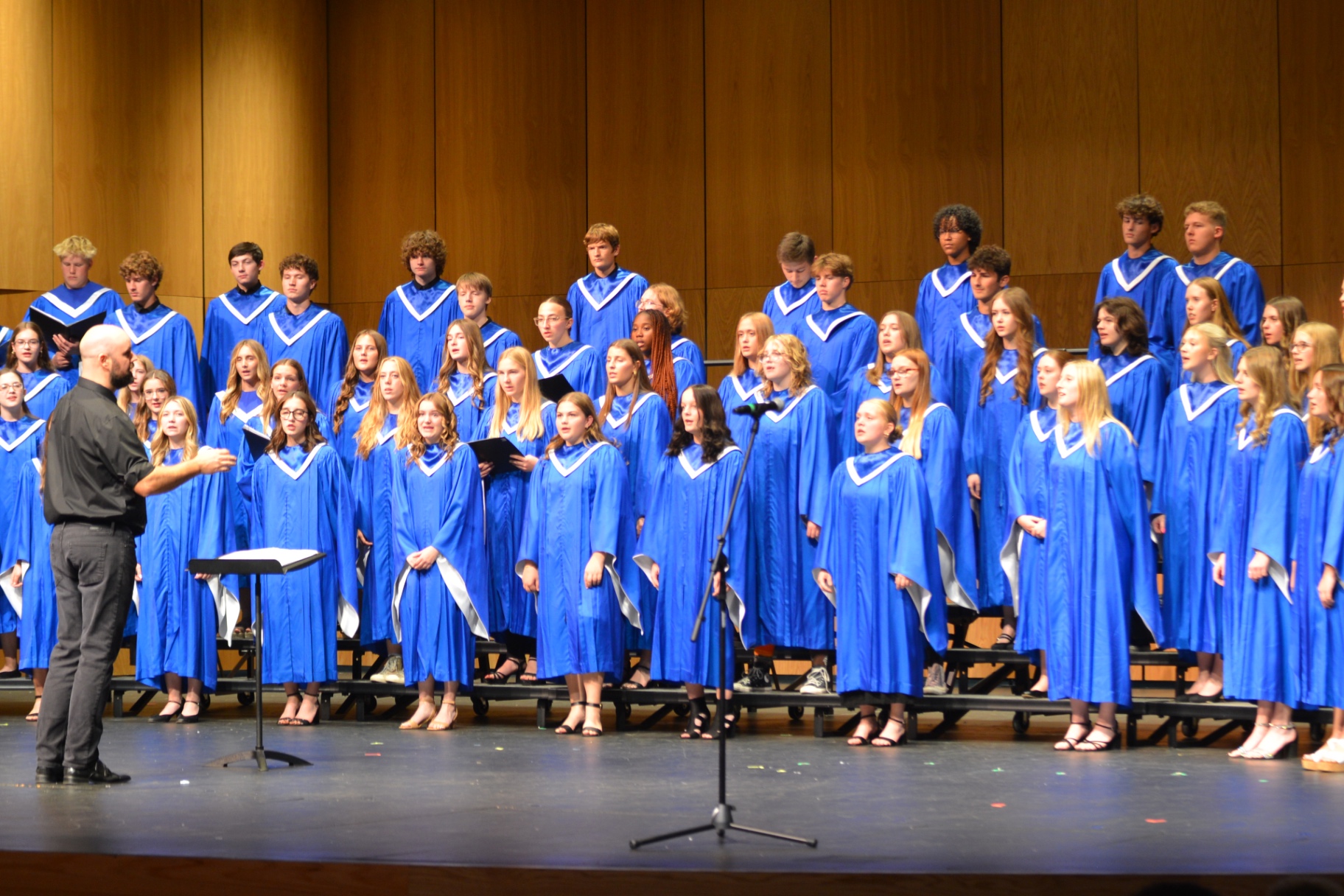 Sartell choir performing in blue concert robes