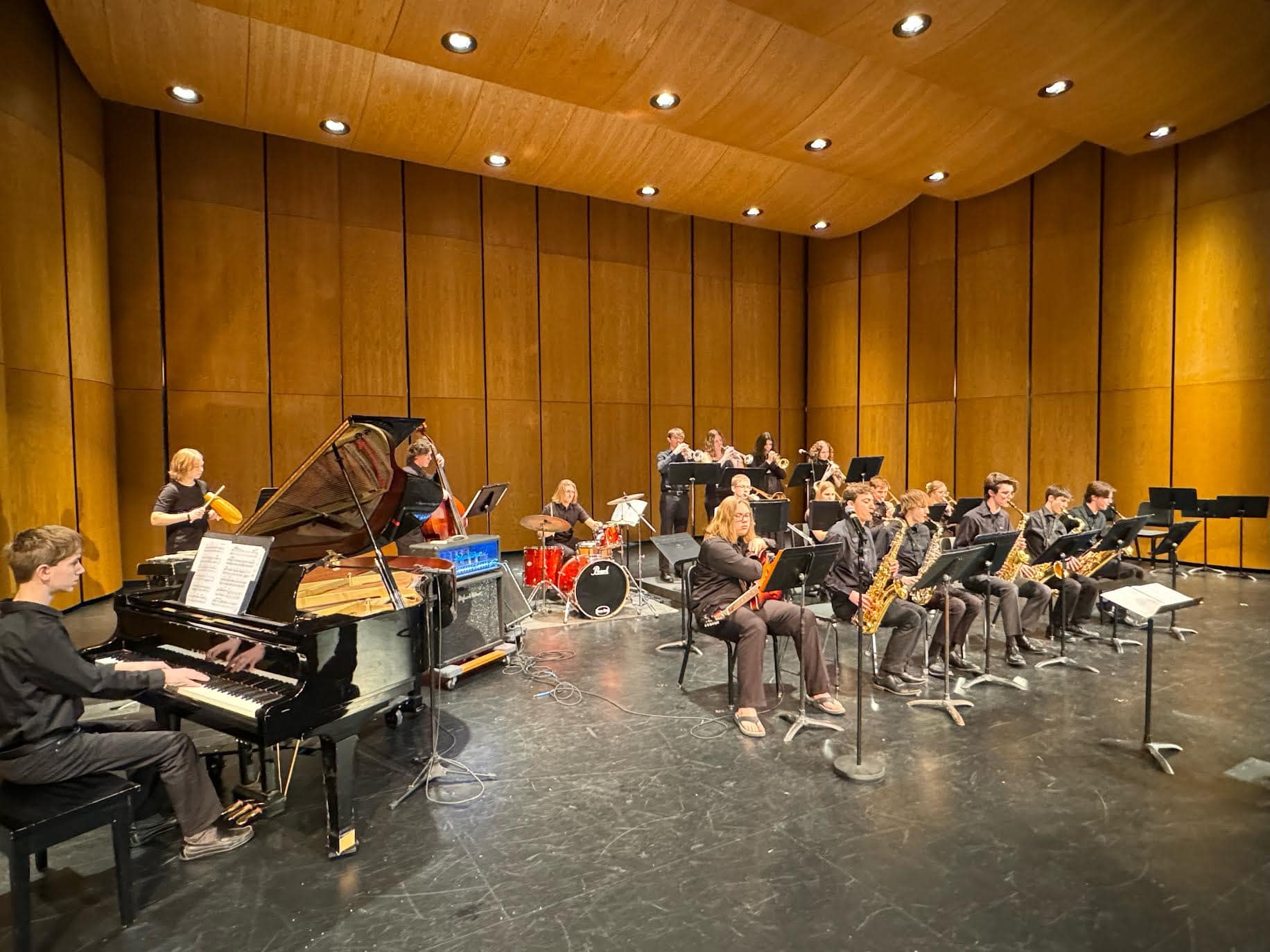 Sartell jazz ensemble performing with piano, upright bass, drums, and horn section